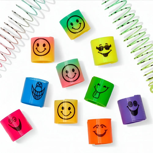 Colorful plastic slinky toys with various smiley face expressions on white background