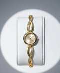 Elegant gold women's bracelet watch with sparkling crystals on an infinity link band