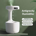 White antigravity humidifier with digital clock and ultrasonic fine fog on green background